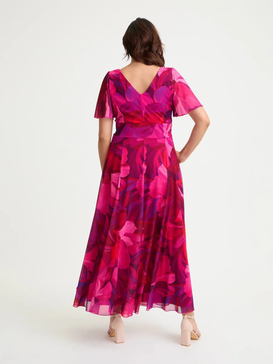 Back view of Scarlett &amp; Jo Isabelle cerise purple maxi dress showing the V-shaped back, floral mesh angel sleeves and flared skirt.